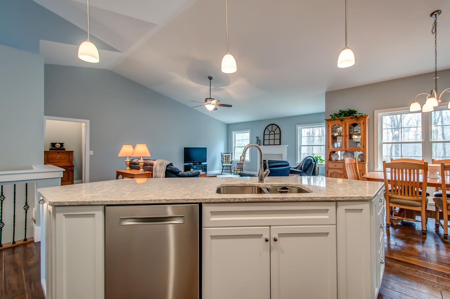 5705 Hopewell Ridge Road Franklin, TN 37064 - Photo 12 of 30 a room with kitchen island a sink and a chandelier