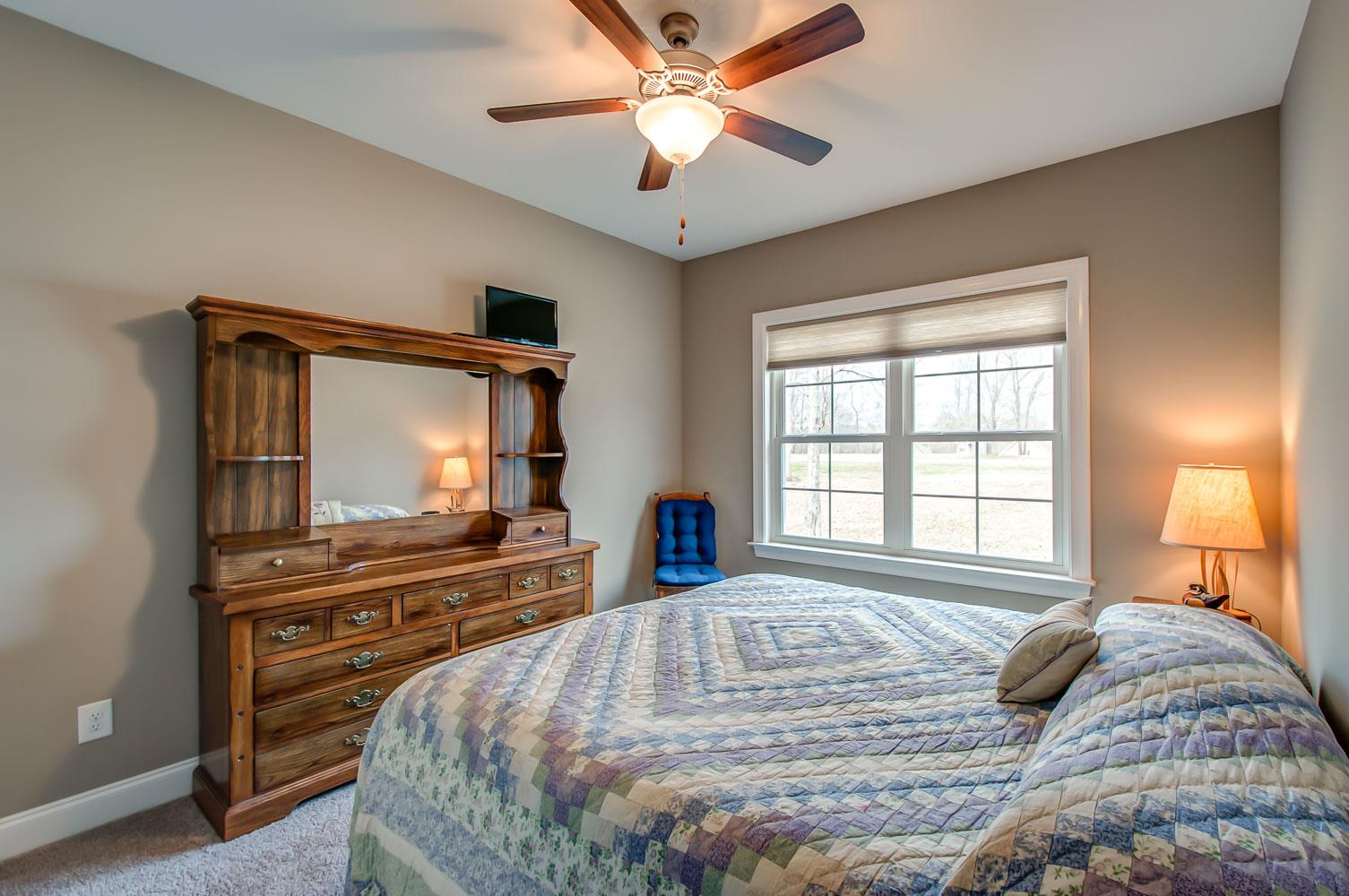 5705 Hopewell Ridge Road Franklin, TN 37064 - Photo 24 of 30 a bedroom with a bed and a flat screen tv with dresser