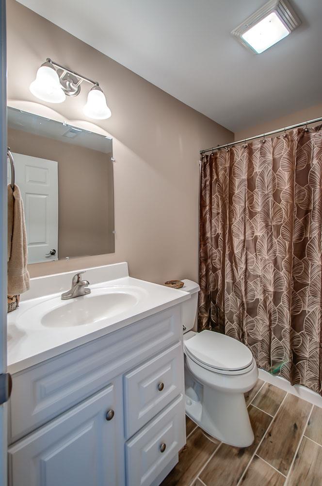 5705 Hopewell Ridge Road Franklin, TN 37064 - Photo 26 of 30 a bathroom with a sink a toilet a mirror and shower curtain