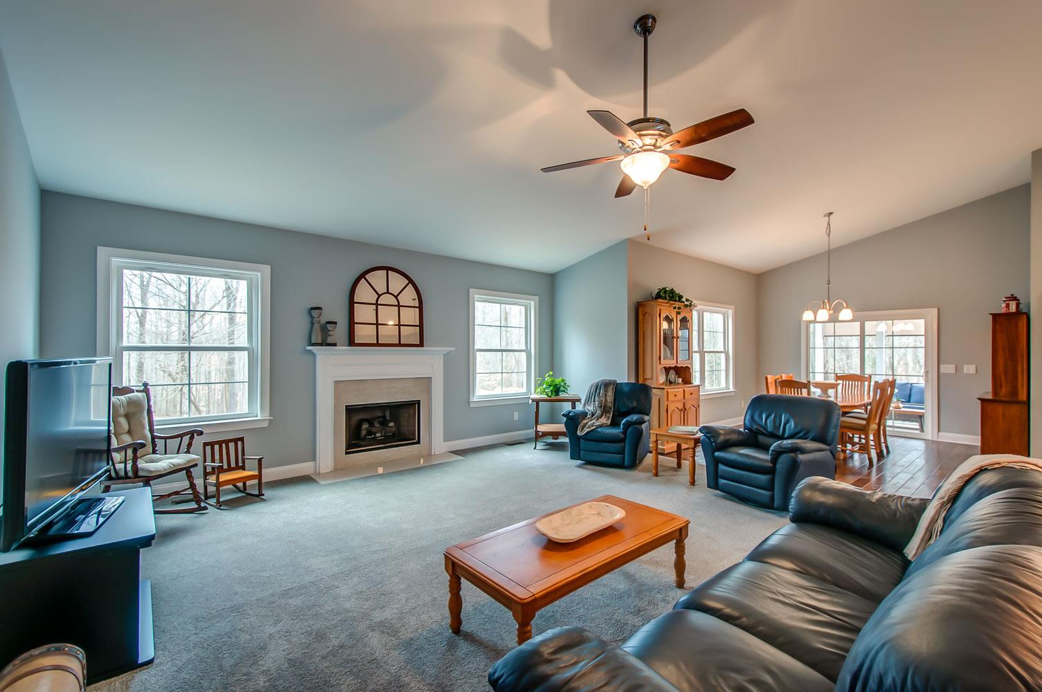 5705 Hopewell Ridge Road Franklin, TN 37064 - Photo 5 of 30 a living room with furniture a fireplace and a large window