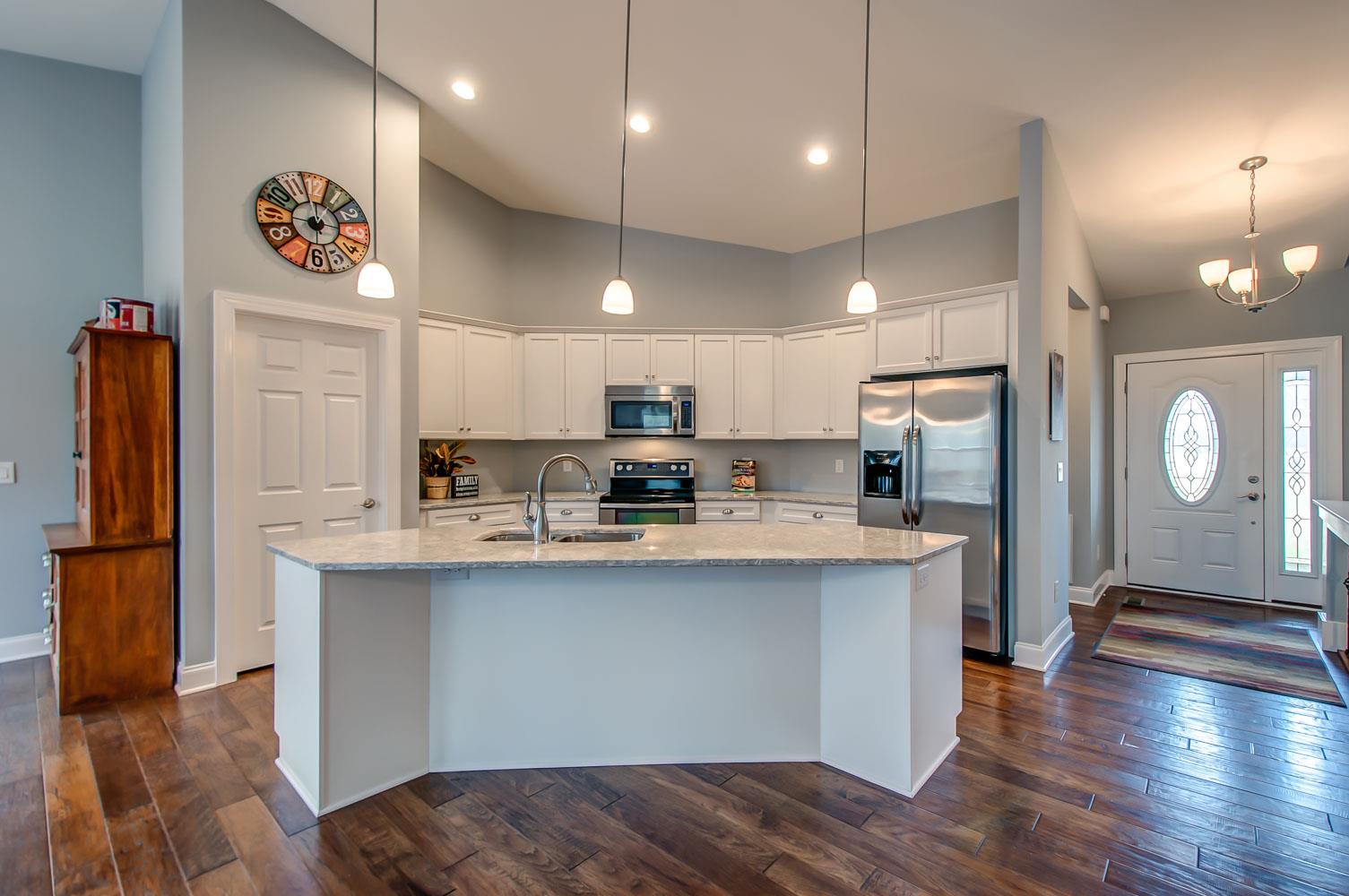 5705 Hopewell Ridge Road Franklin, TN 37064 - Photo 10 of 30 a open kitchen with stainless steel appliances granite countertop a refrigerator a sink dishwasher a stove and a refrigerator with wooden floor