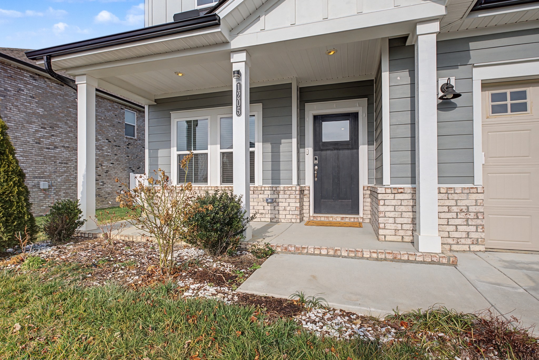 1205 Bridgett Way Mount Juliet, TN 37122 - Photo 4 of 43 front view of a brick house with a small yard