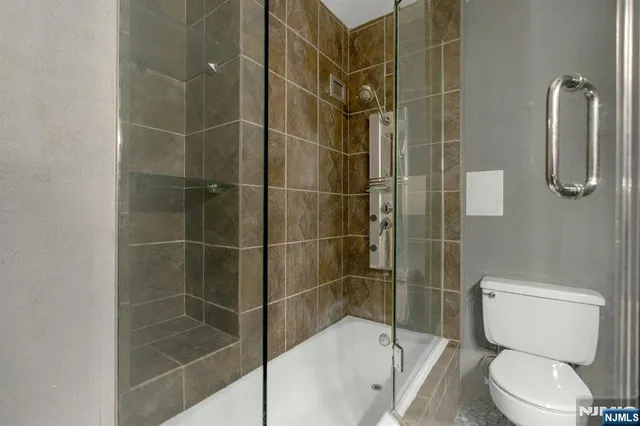 a bathroom with a toilet and a shower