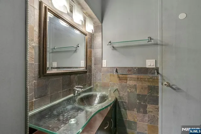 a bathroom with a shower sink and mirror
