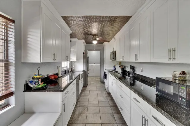 a kitchen with a stove a microwave and a refrigerator