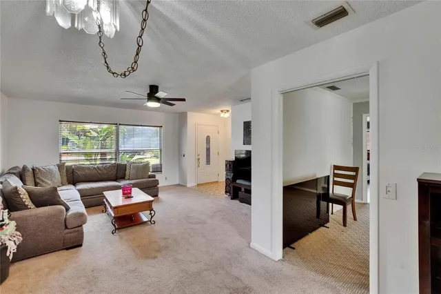 a view of a hallway with entryway and stairs