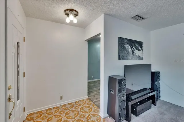 a dining room with furniture and chandelier fan