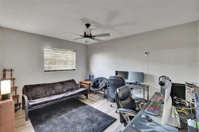 a bedroom with a bed and ceiling fan