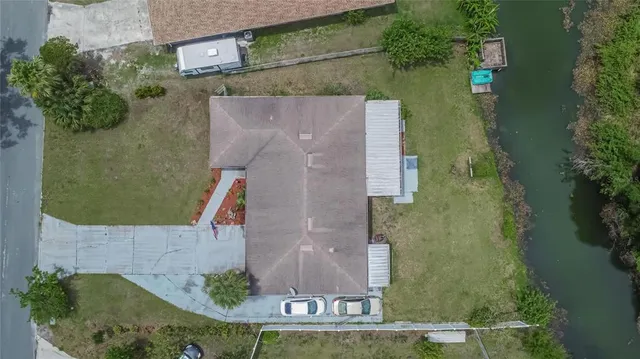 an aerial view of a house with a yard