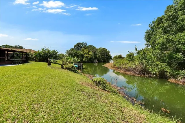 a view of a lake with houses in the back