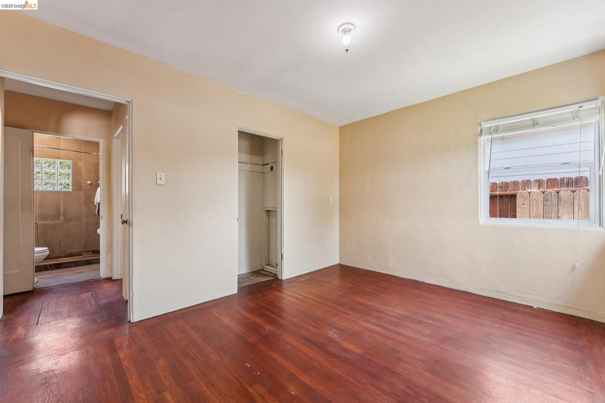 2879 Rheem Avenue Richmond, CA 94804 - Photo 30 of 45 Hardwood flooring throughout, with a single window offering natural light