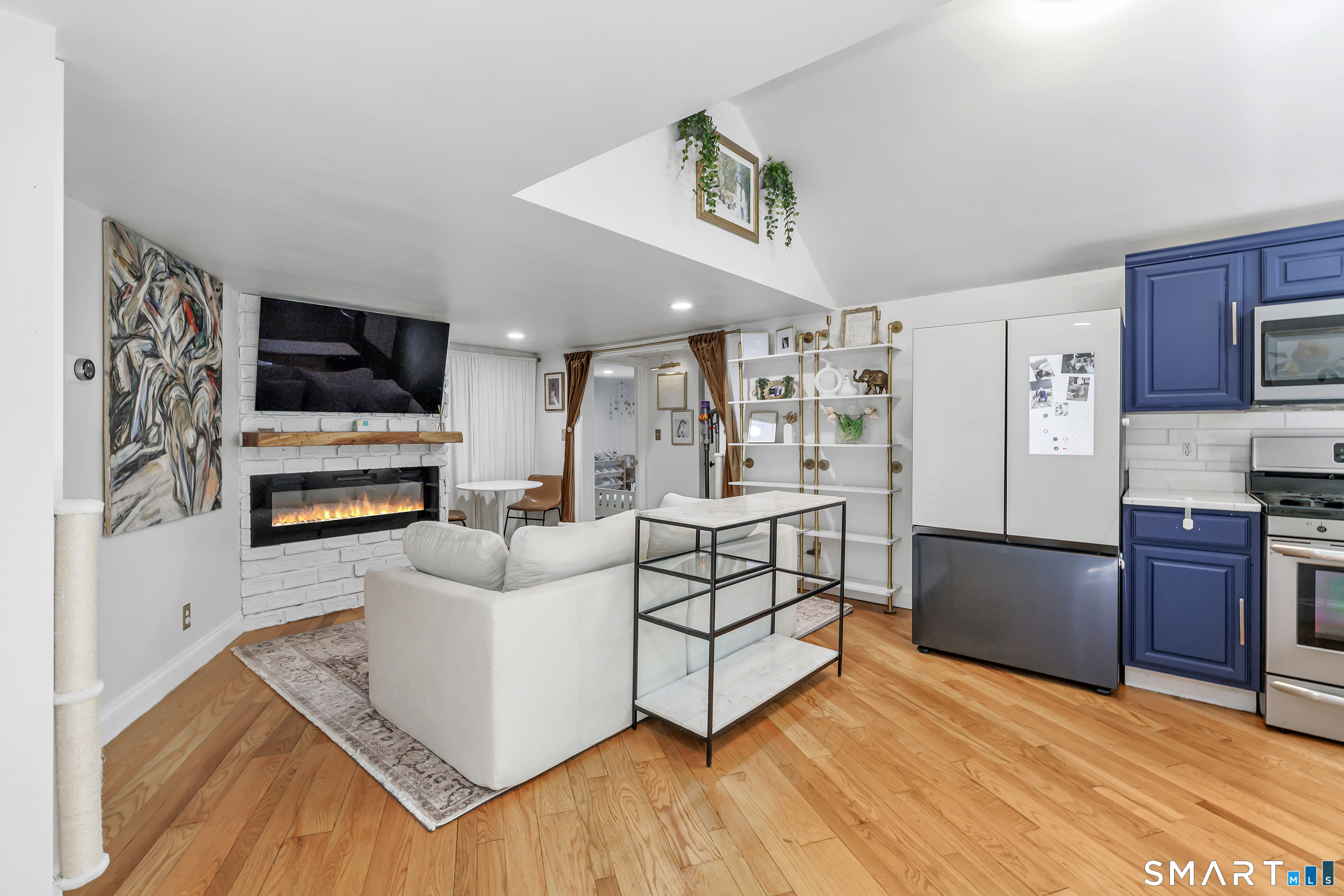 57 Olmstead Road Redding, CT 06896 - Photo 6 of 22 a living room with stainless steel appliances furniture and a flat screen tv