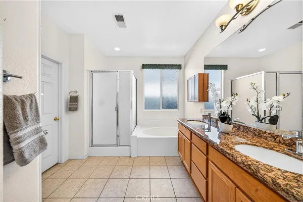 a large bathroom with a tub sink and mirror