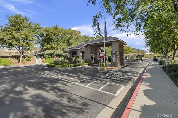a kitchen with stainless steel appliances granite countertop a refrigerator a sink dishwasher a oven and white cabinets