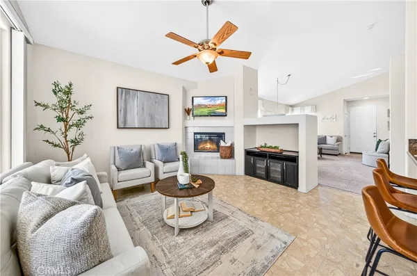 a living room with furniture and kitchen view