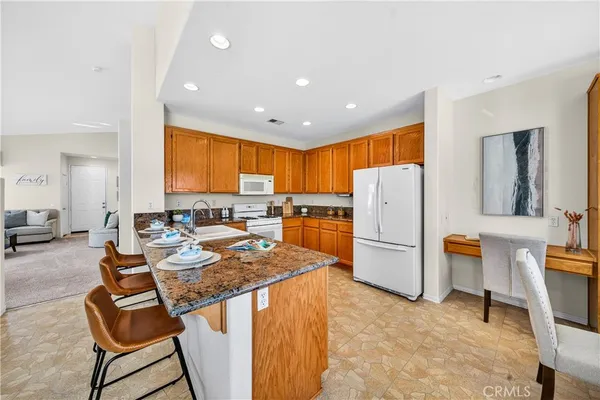 a kitchen with a refrigerator and a stove top oven
