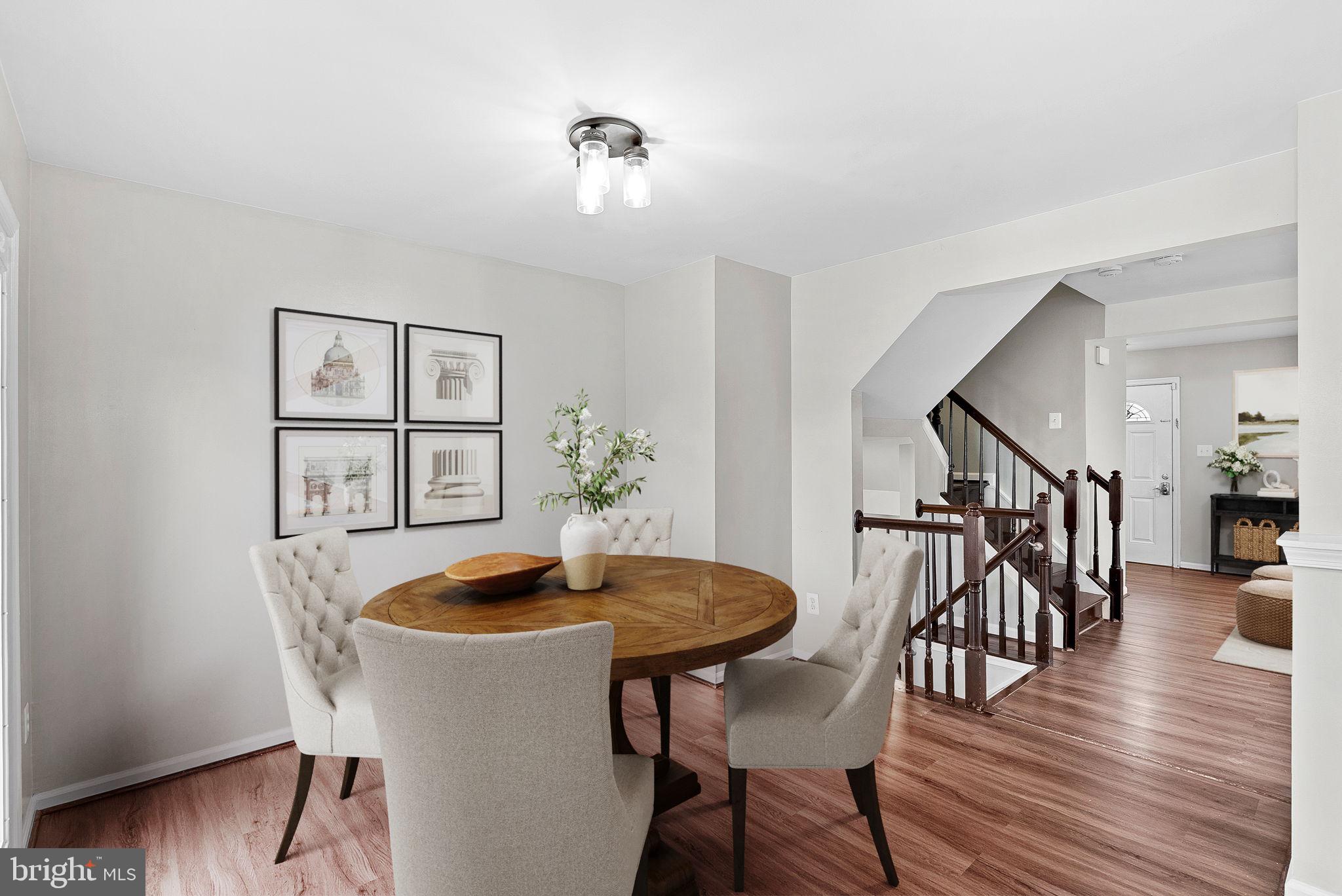 21074 Cornerpost Square Ashburn, VA 20147 - Photo 16 of 81 a view of a dining room with furniture and wooden floor