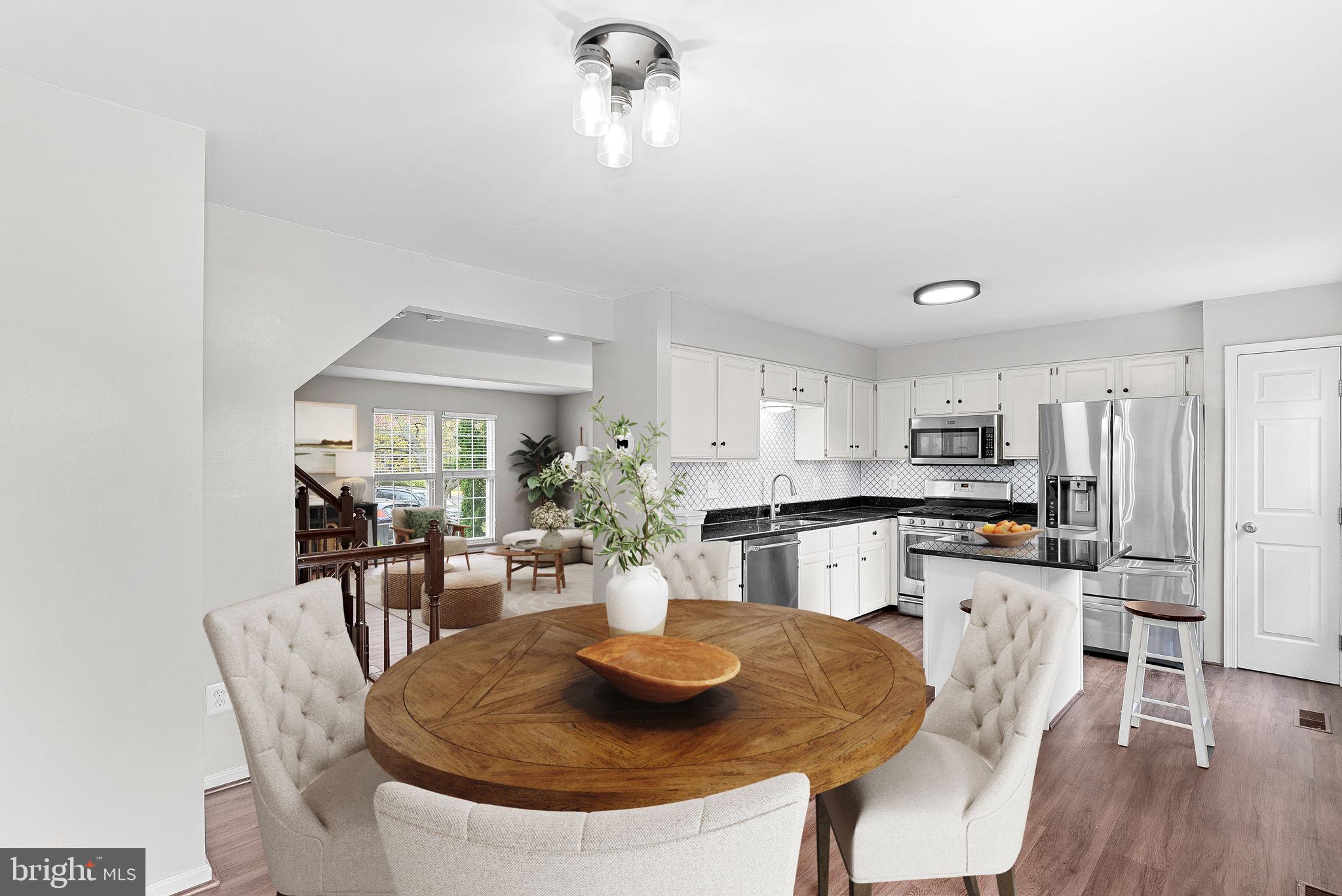 21074 Cornerpost Square Ashburn, VA 20147 - Photo 17 of 81 a kitchen with granite countertop kitchen island stainless steel appliances a table and chairs
