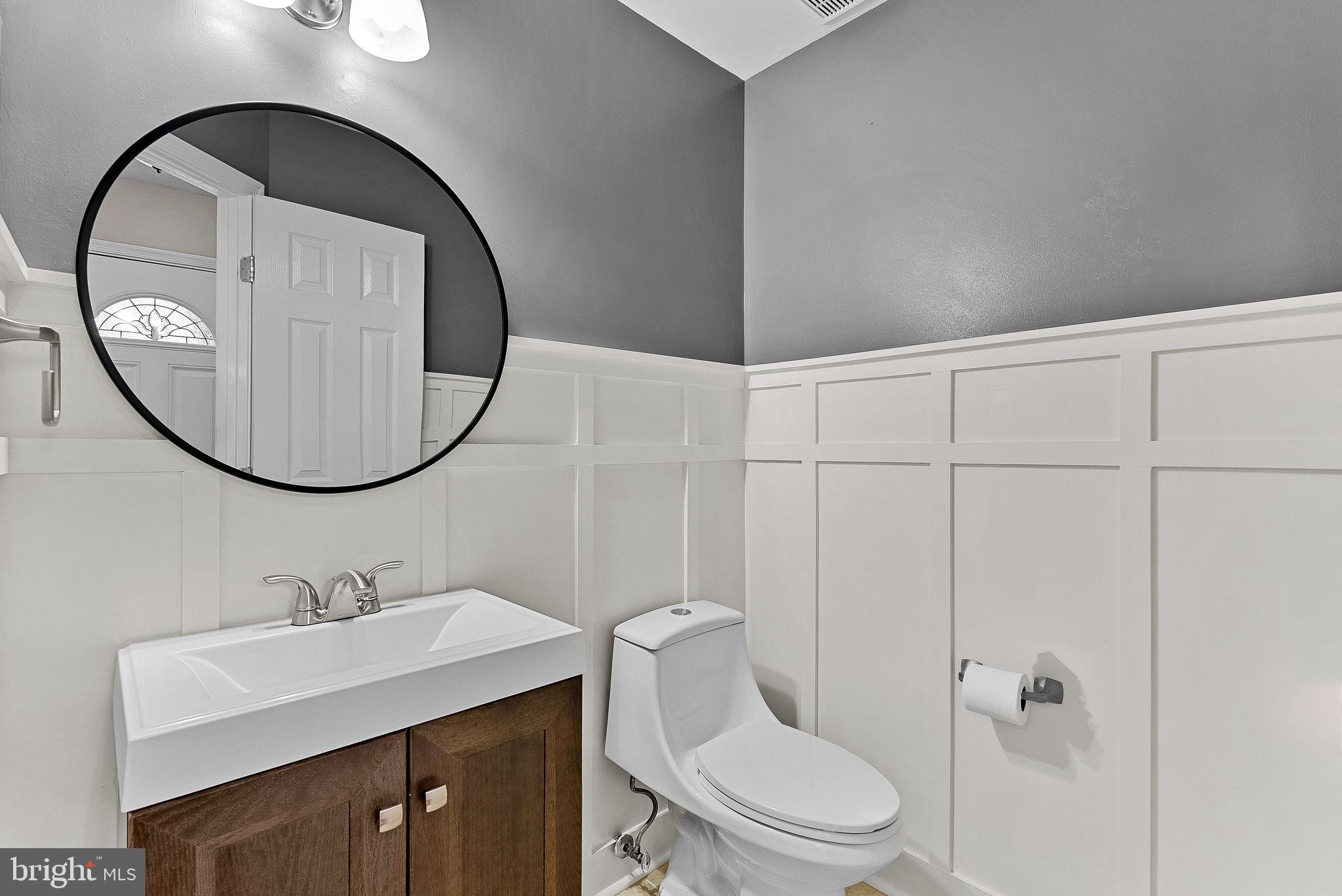 21074 Cornerpost Square Ashburn, VA 20147 - Photo 20 of 81 a bathroom with a sink a toilet and a mirror