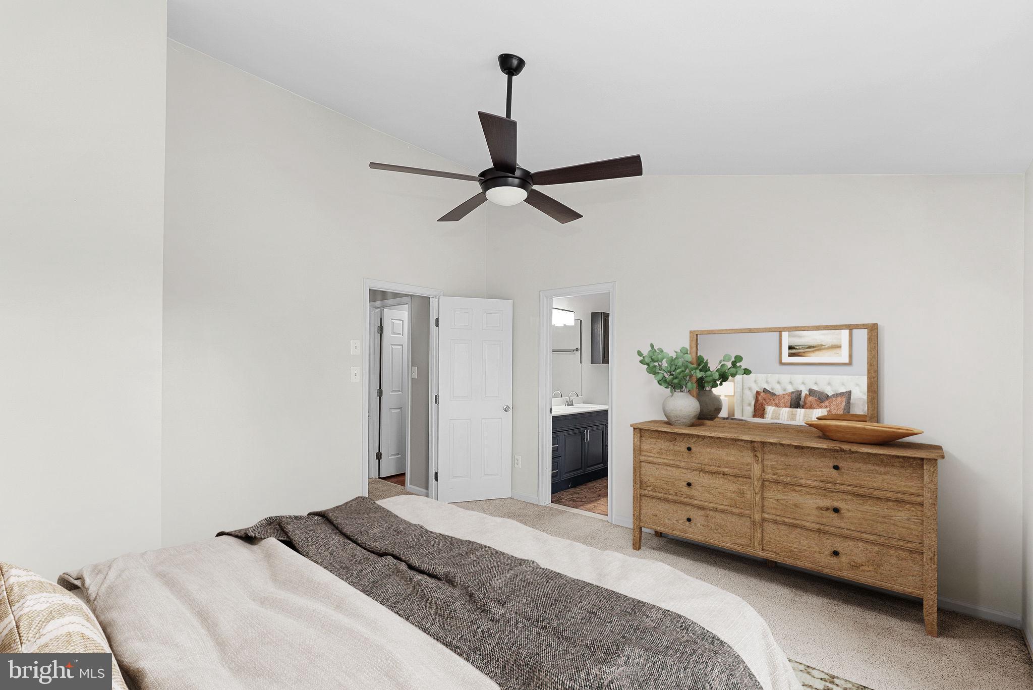 21074 Cornerpost Square Ashburn, VA 20147 - Photo 23 of 81 a bedroom with a bed and a chandelier fan