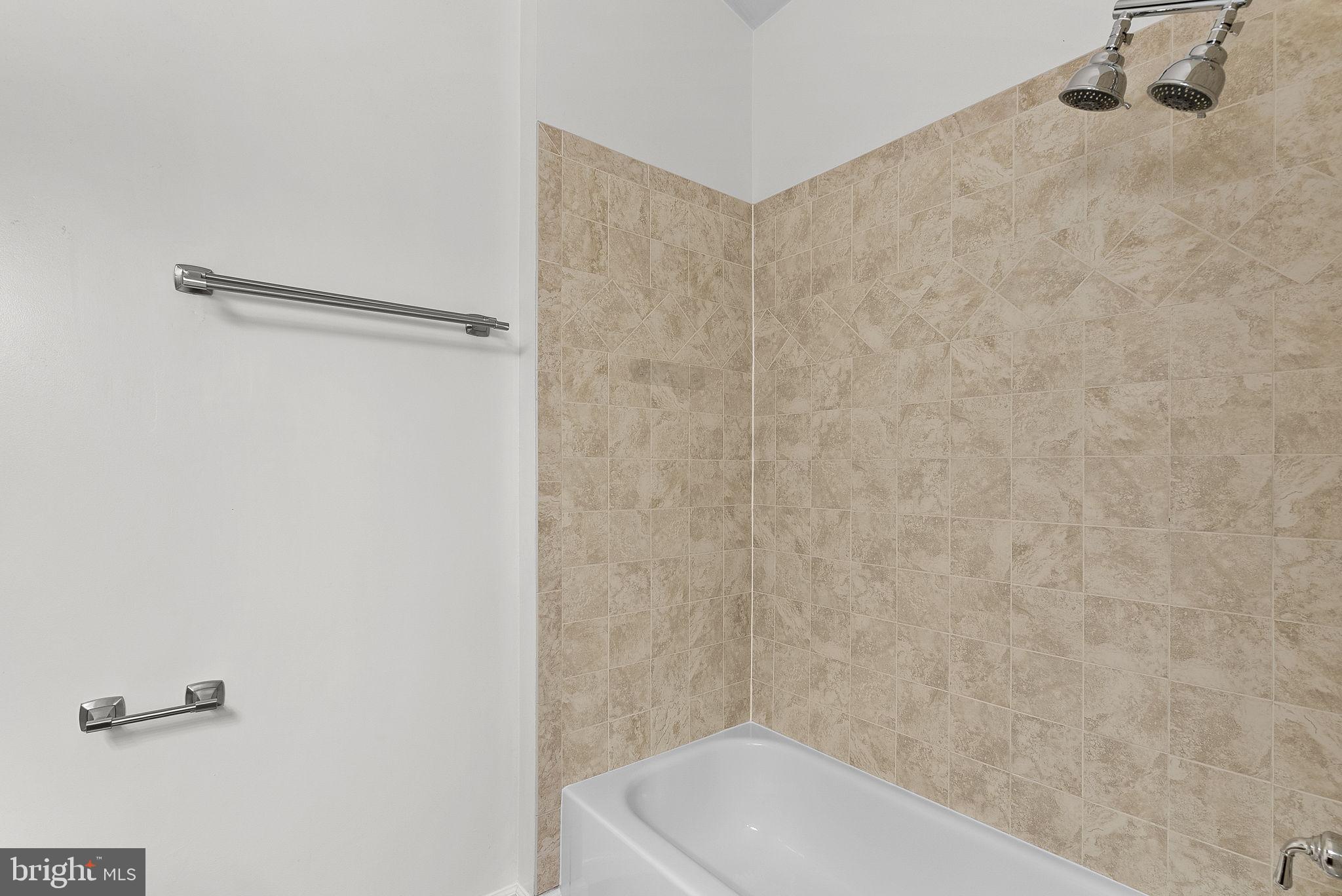 21074 Cornerpost Square Ashburn, VA 20147 - Photo 28 of 81 a bathroom with a white bath tub