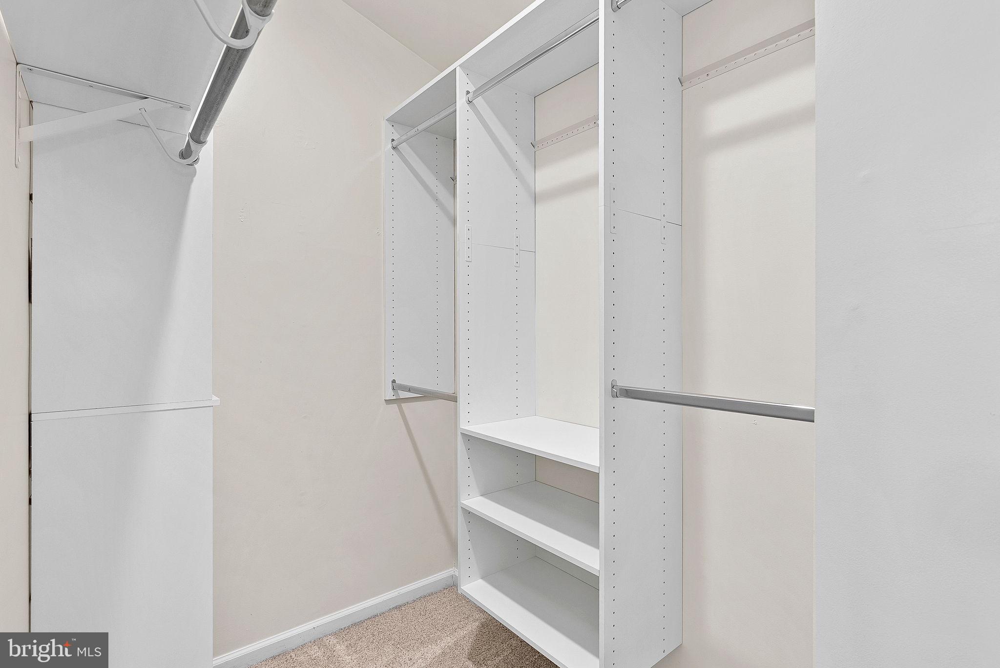 21074 Cornerpost Square Ashburn, VA 20147 - Photo 29 of 81 a view of walk in closet with empty racks