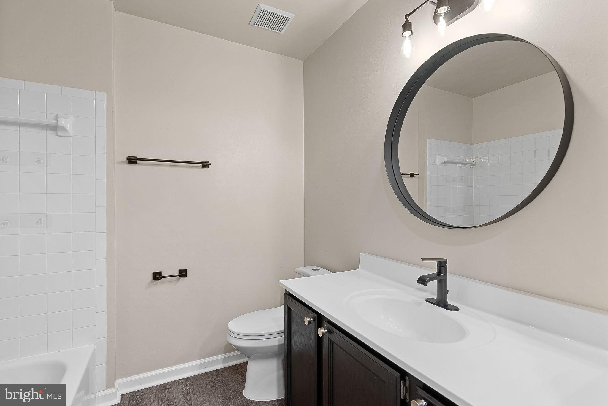 21074 Cornerpost Square Ashburn, VA 20147 - Photo 30 of 81 a bathroom with a sink a toilet and a mirror