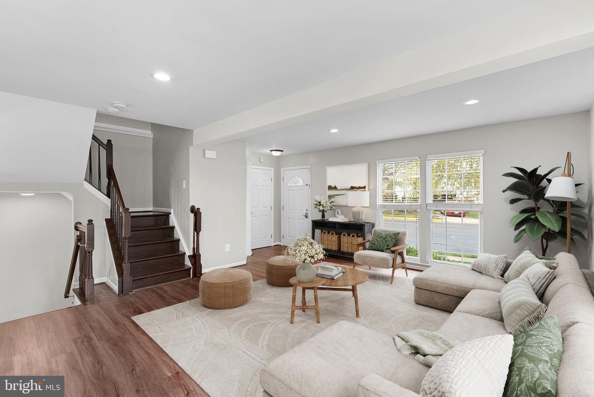 21074 Cornerpost Square Ashburn, VA 20147 - Photo 3 of 81 a living room with furniture and a flat screen tv