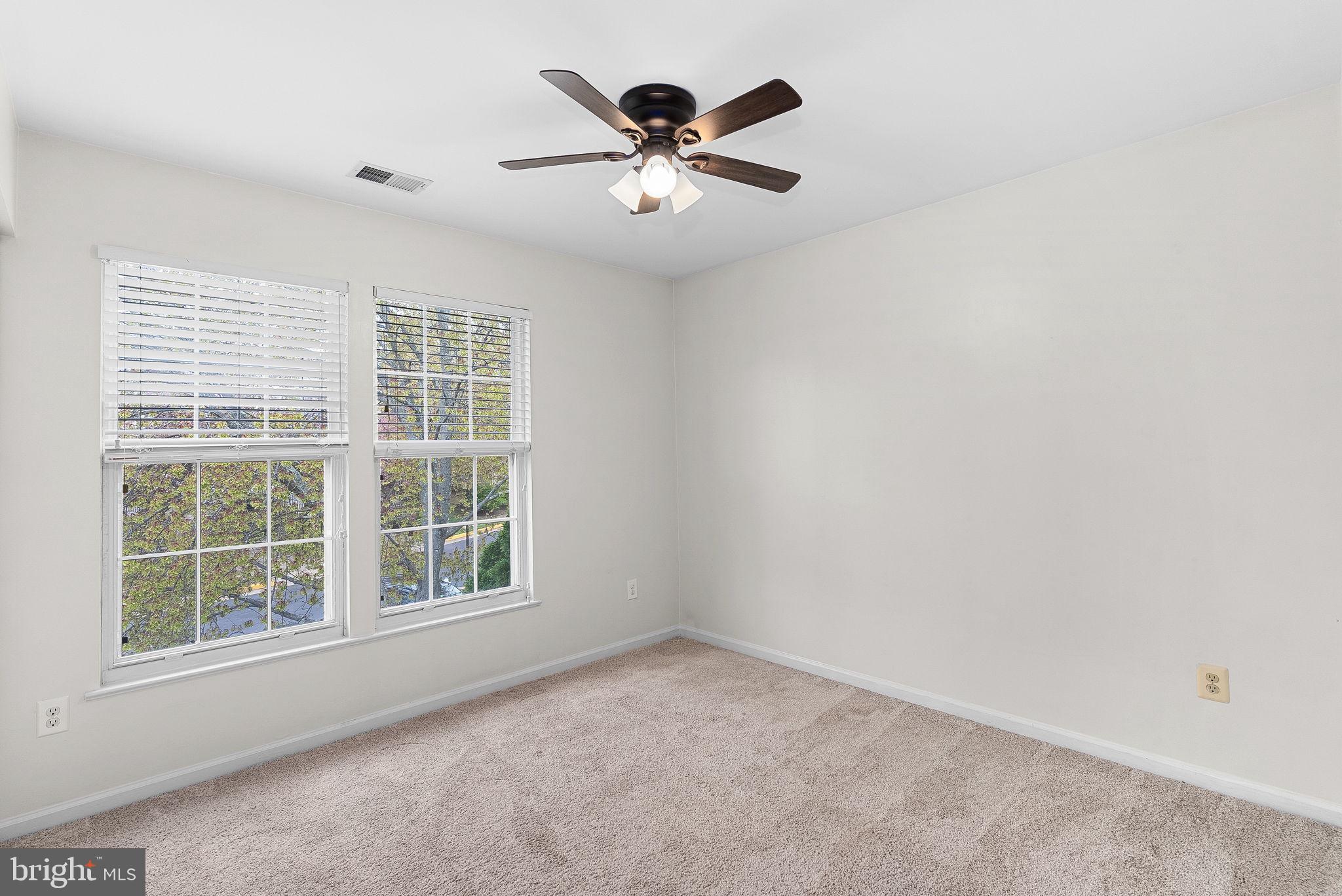 21074 Cornerpost Square Ashburn, VA 20147 - Photo 32 of 81 an empty room with window and a ceiling fan