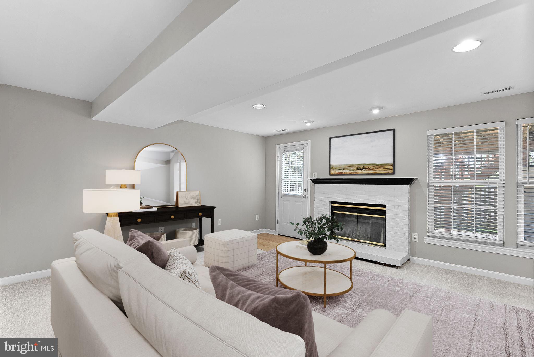 21074 Cornerpost Square Ashburn, VA 20147 - Photo 38 of 81 a living room with furniture a window and a fireplace