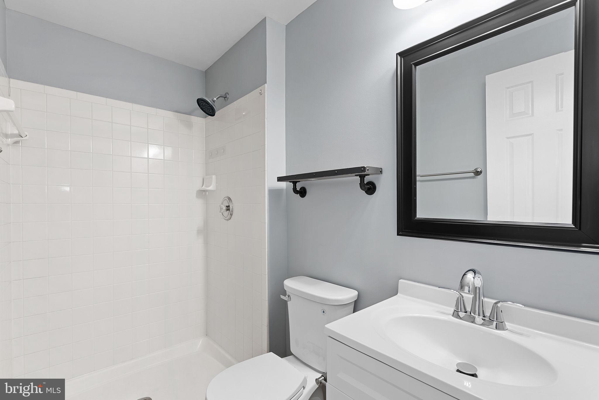 21074 Cornerpost Square Ashburn, VA 20147 - Photo 47 of 81 a bathroom with a sink toilet and shower