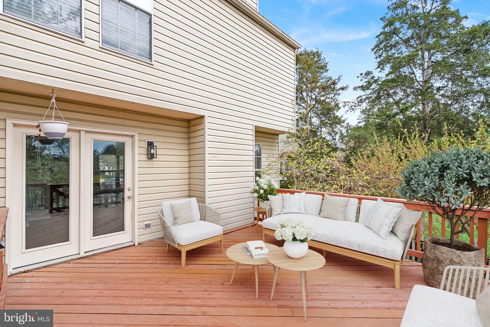 21074 Cornerpost Square Ashburn, VA 20147 - Photo 50 of 81 a view of a patio with couches and a potted plant on a wooden floor
