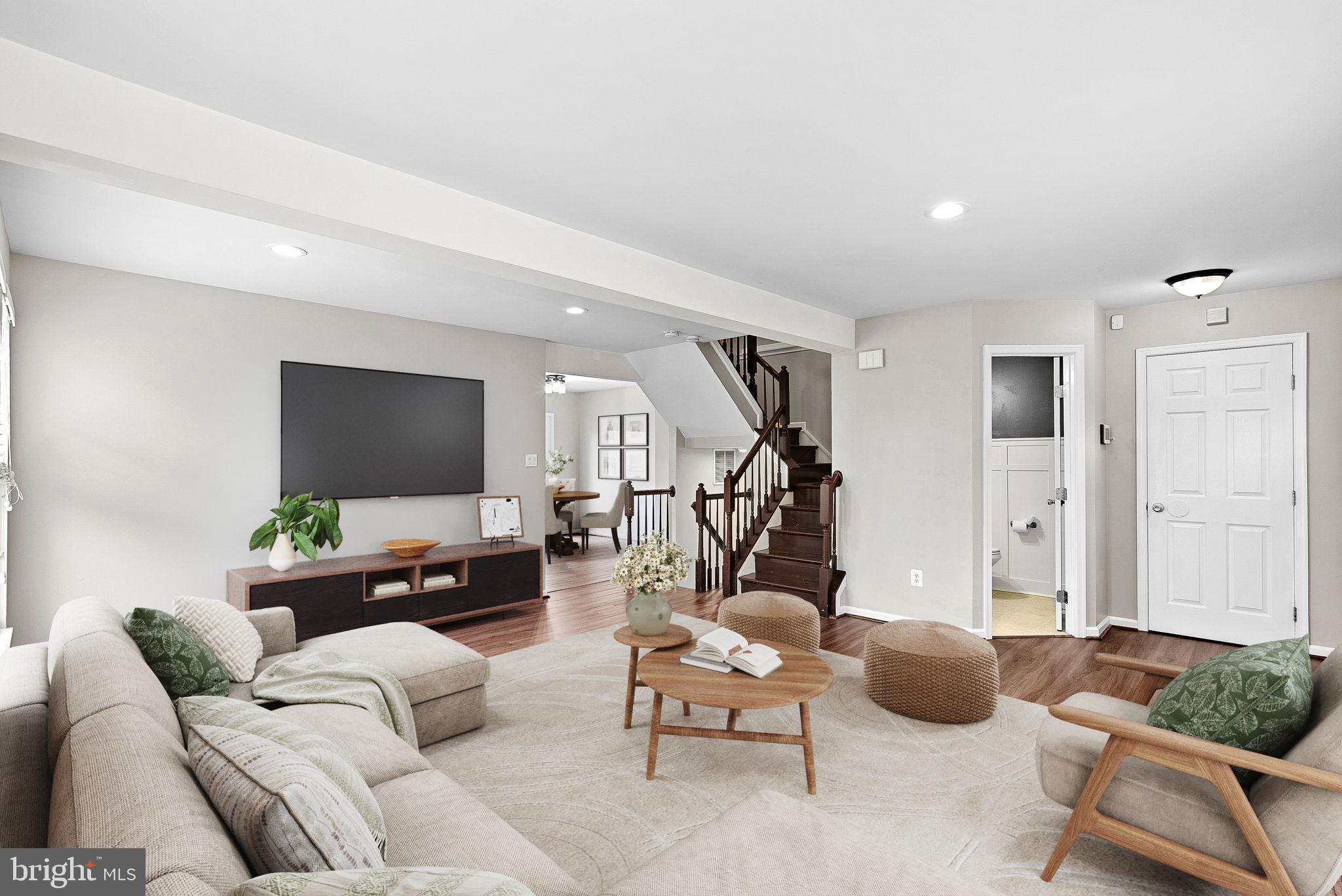 21074 Cornerpost Square Ashburn, VA 20147 - Photo 5 of 81 a living room with furniture and a flat screen tv