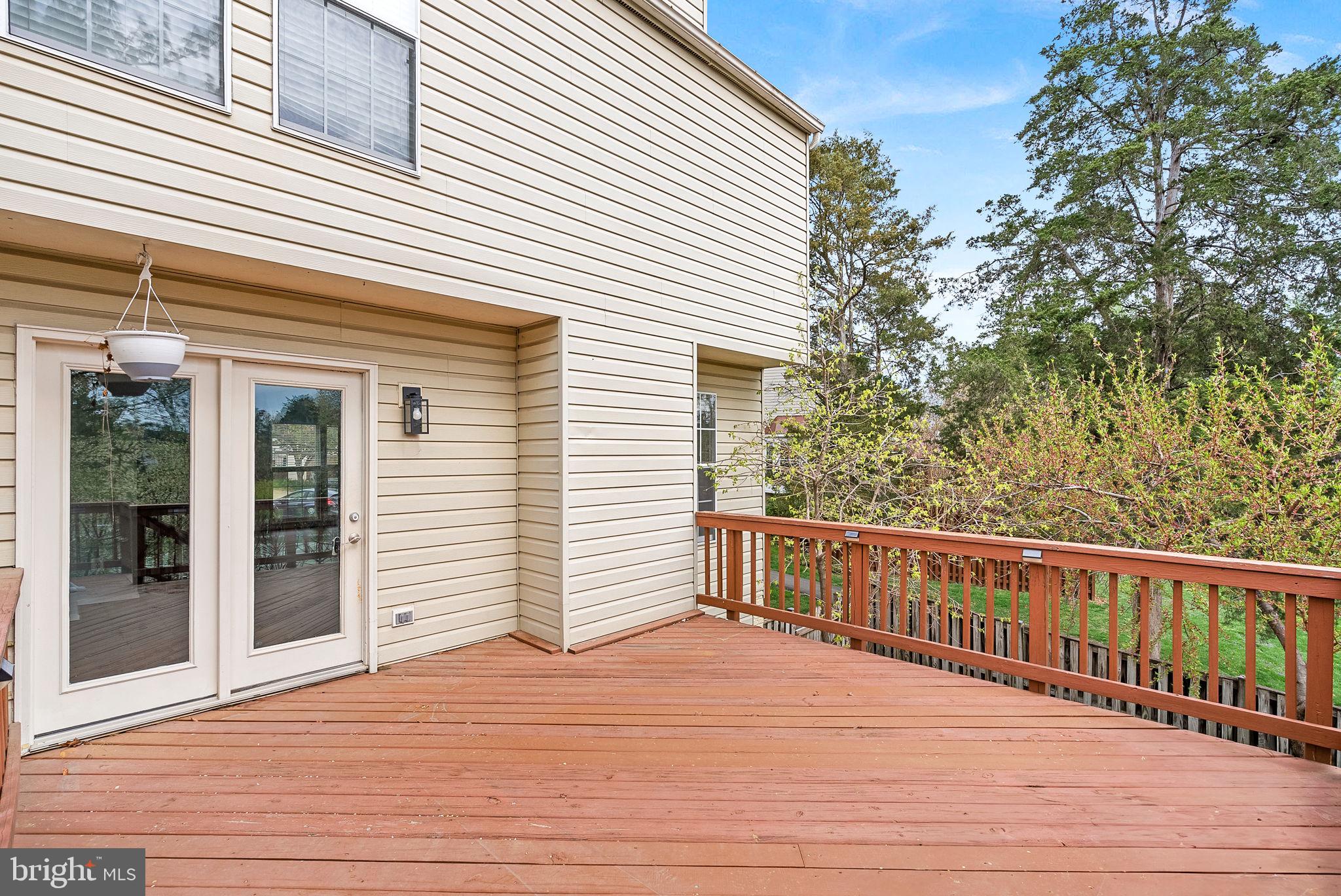 21074 Cornerpost Square Ashburn, VA 20147 - Photo 53 of 81 a view of a balcony with wooden floor and fence