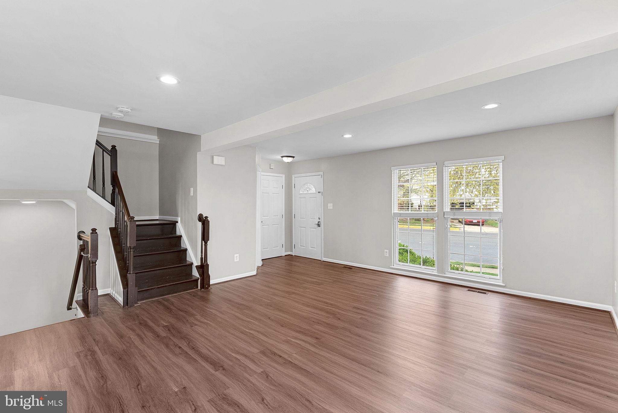 21074 Cornerpost Square Ashburn, VA 20147 - Photo 8 of 81 a view of empty room with wooden floor and window