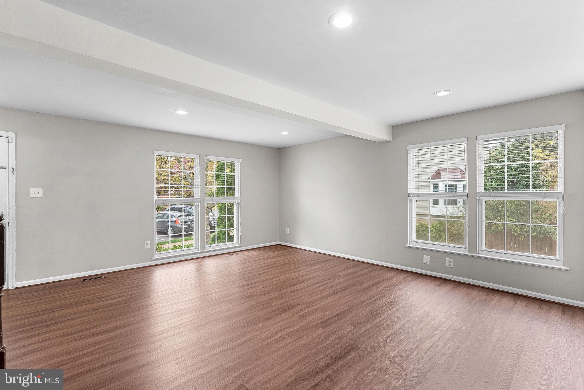 21074 Cornerpost Square Ashburn, VA 20147 - Photo 9 of 81 a view of an empty room with wooden floor and a window