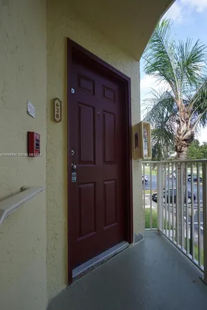 a view of a hallway with entryway door