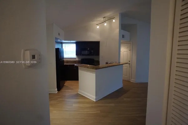 a kitchen with stainless steel appliances a microwave and a refrigerator