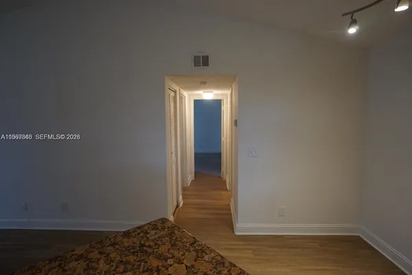 a view of hallway with wooden floor