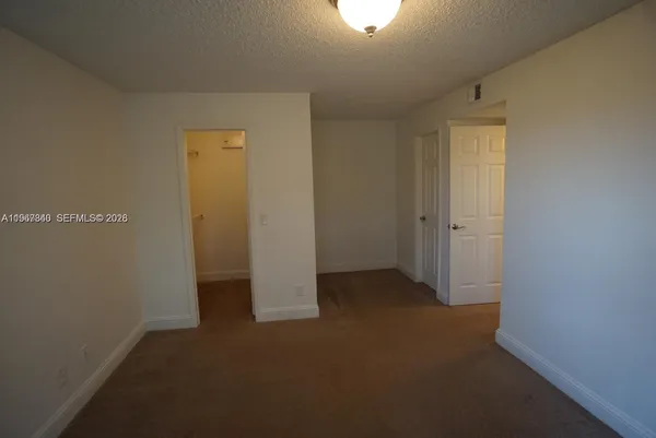 an empty room with closet area