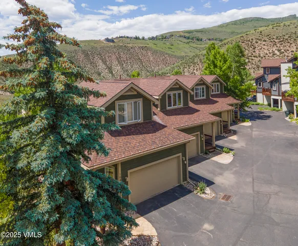 an aerial view of a house with a yard