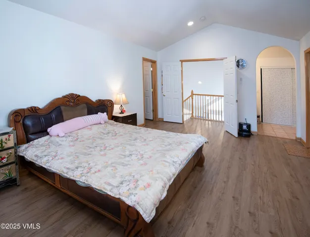 a room with a bed and wooden floor