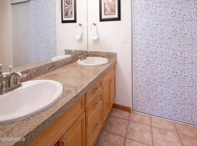 a bathroom with a tub sink and mirror