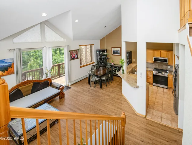 a living room with furniture a wooden floor and next to a window