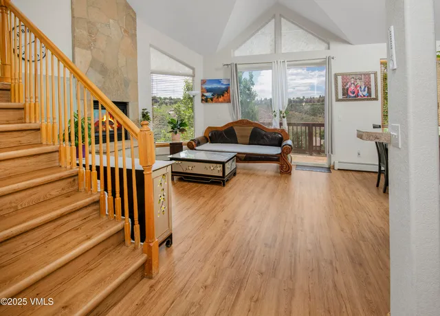 a living room with wooden floor furniture and a table