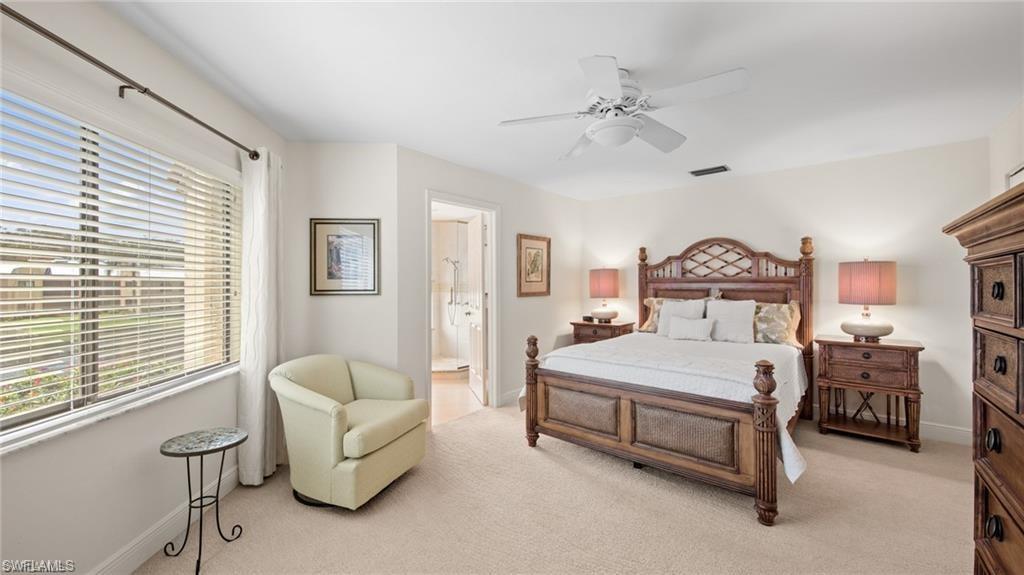 577 Beachwalk Circle, Unit R202 Naples, FL 34108 - Photo 19 of 44 Bedroom with light colored carpet and ceiling fan