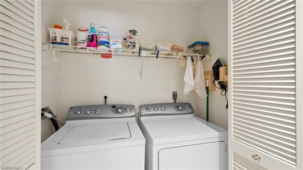 577 Beachwalk Circle, Unit R202 Naples, FL 34108 - Photo 25 of 44 Laundry area featuring separate washer and dryer