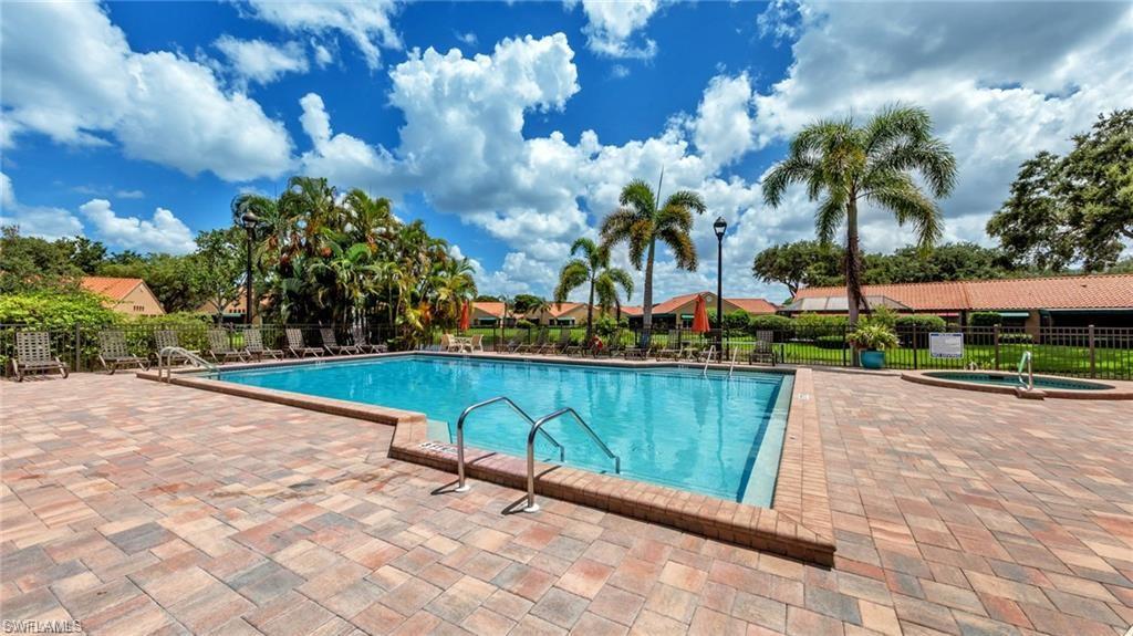577 Beachwalk Circle, Unit R202 Naples, FL 34108 - Photo 38 of 44 Community pool featuring a patio and a hot tub