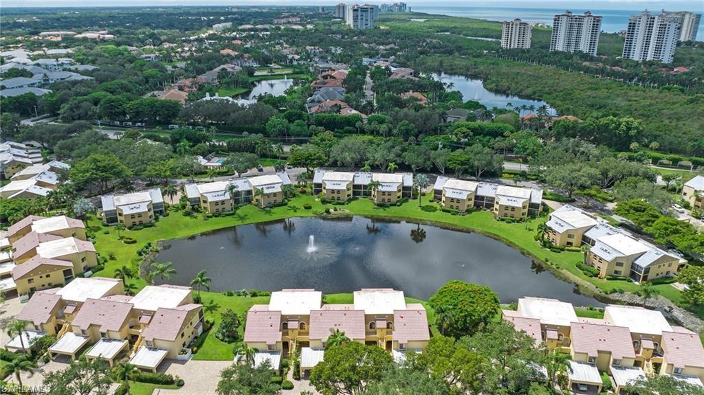 577 Beachwalk Circle, Unit R202 Naples, FL 34108 - Photo 42 of 44 Aerial view of residential area featuring a large body of water