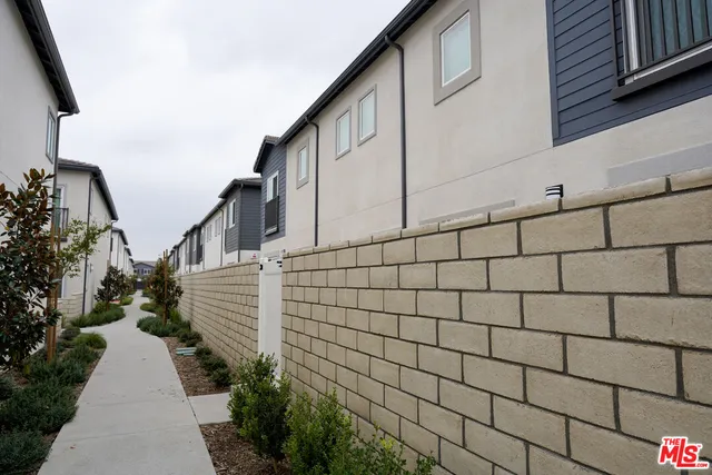 a view of a pathway along the house